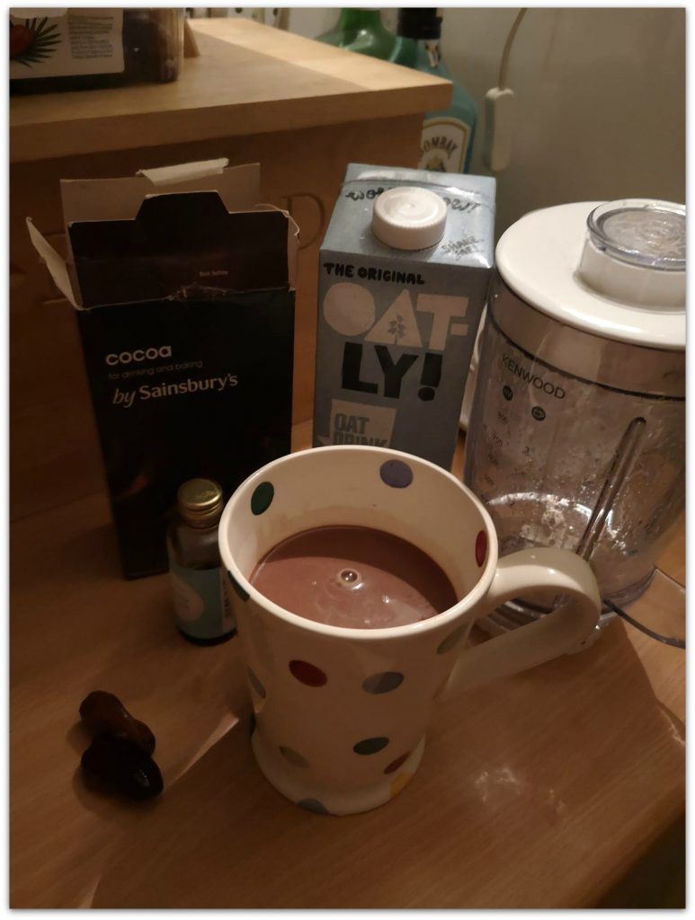 Hot chocolate ingredients, and a blender, carton of oat milk